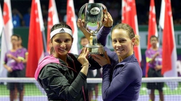 Mira and Black holding the WTA Trophy after an historic win