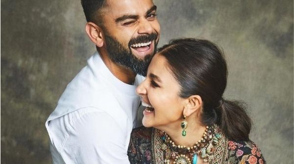Virat Kohli Height looking more than his wife as both laugh and lean forward to pose