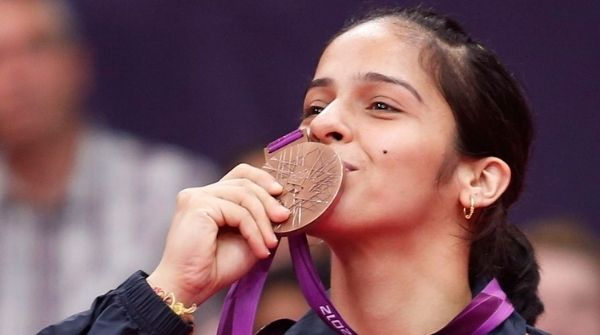 Image of Saina Nehwal kissing the Bronze medal that she won in the 2012 London Olympics